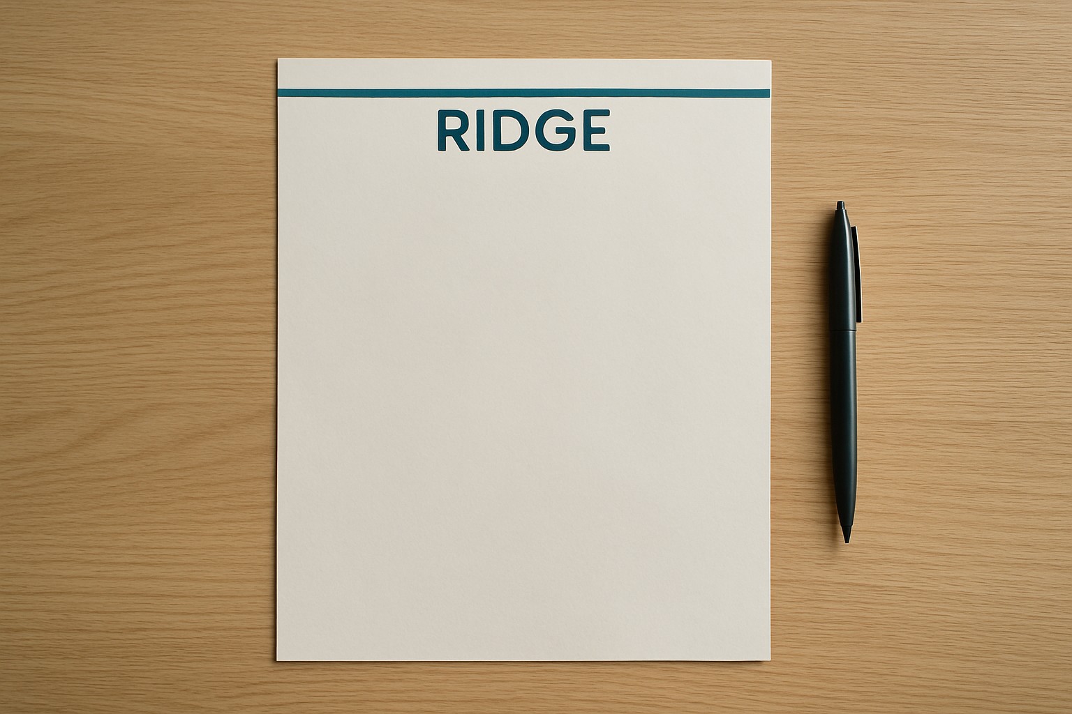 Eight-and-a-half by eleven inch white letterhead on a desk with a header mark and an empty writing area