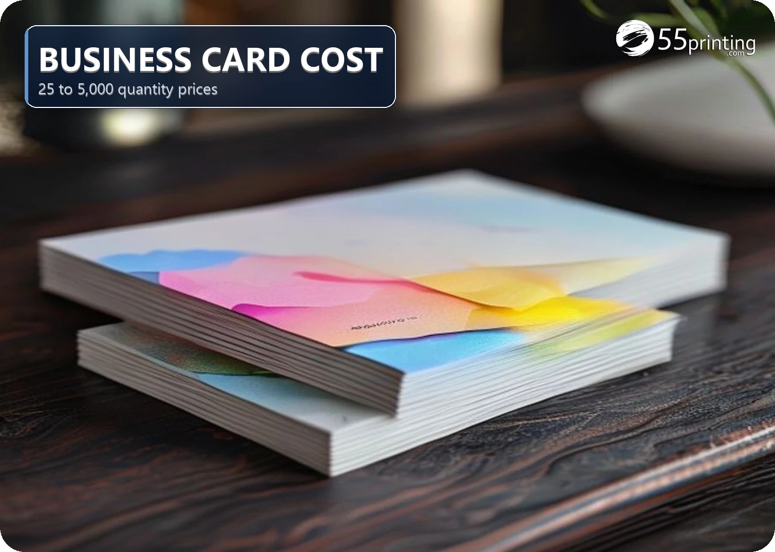 Stack of full-color standard business cards on a wooden desk